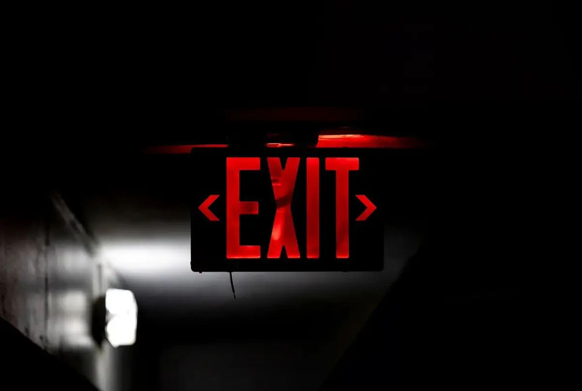 Red Emergency Exit Sign in an Australian Workplace